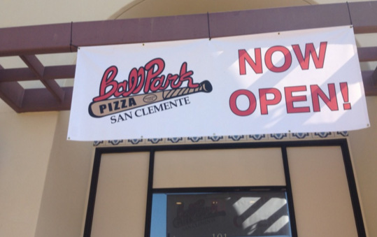 A banner hanged on a pizza store front door