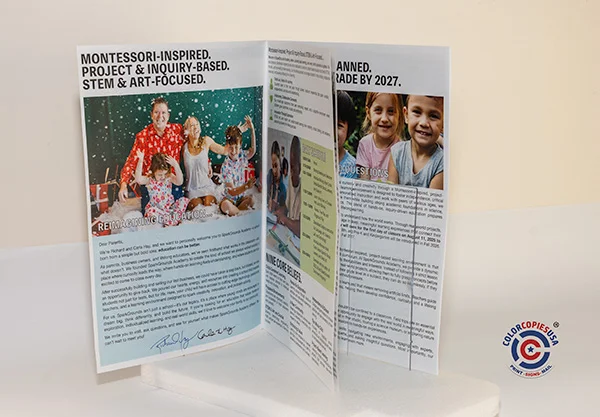 Close up of saddle stitch staples neatly securing the spine of a booklet