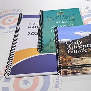 Spiral-bound educational workbooks and guides laying flat