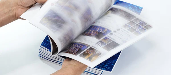 Close-up of a saddle-stitched booklet spine showing the wire staples